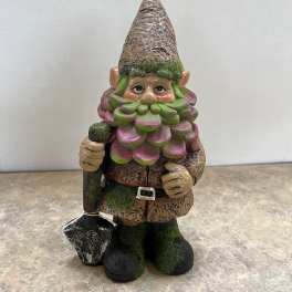 Garden gnome figurine holding a shovel