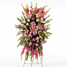 Tall pink floral standing spray on an easel