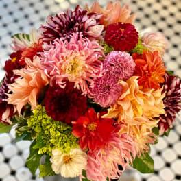 Mixed bouquet of colorful dahlias with green foliage