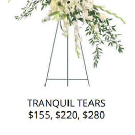 White floral standing spray on an easel