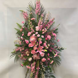 Large pink floral standing spray with lilies and carnations