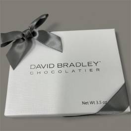 White chocolate gift box tied with a gray ribbon