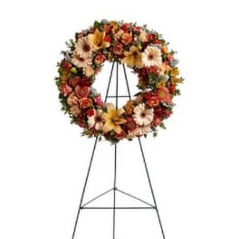 Floral wreath on a metal easel stand