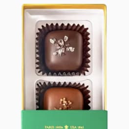Box of sea salt caramels in a clear tray with green label
