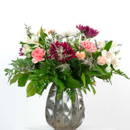 Mixed bouquet in a silver vase with pink, white, and purple flowers
