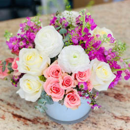Bouquet of pink and white roses in a white vase