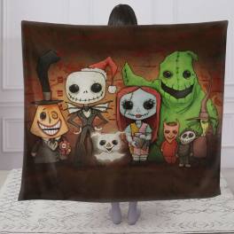 Person holding a Halloween blanket with cartoon monster characters