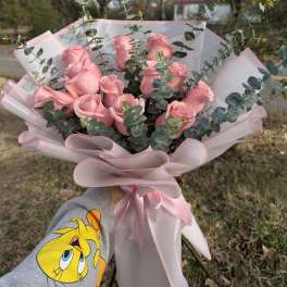 Pink rose bouquet with eucalyptus wrapped in pale pink paper
