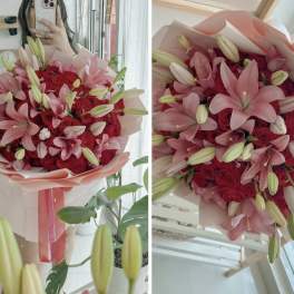 Pink lily and red rose bouquet wrapped in pale paper