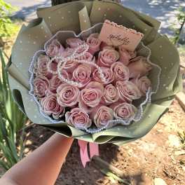 Pink rose bouquet wrapped in sage paper with pearl accents