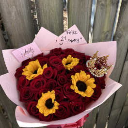 Bouquet of red roses and yellow sunflowers wrapped in pink paper
