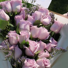 Bouquet of pale pink roses with purple filler flowers