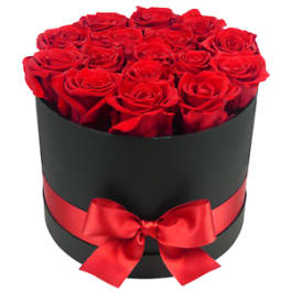 Round black hatbox of red roses with a red ribbon and bow