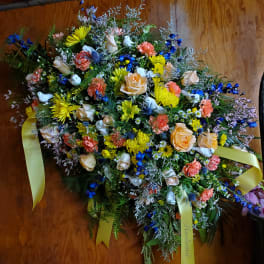 Large mixed floral spray with yellow ribbons and white doves
