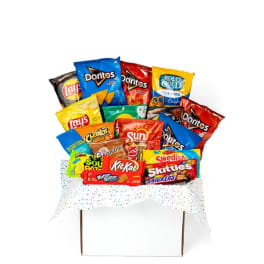 Assorted snack bags arranged in a gift basket with confetti wrap