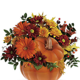 Pumpkin-shaped vase with orange and red flowers