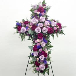 Cross-shaped floral spray with lavender roses and purple blooms
