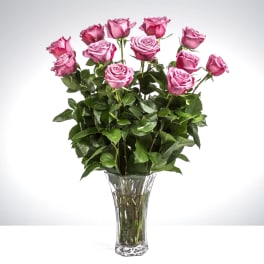 Pink roses arranged in a clear glass vase