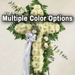 White floral standing spray shaped like a cross with a ribbon