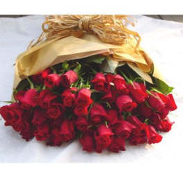 Bouquet of red roses wrapped in tan paper