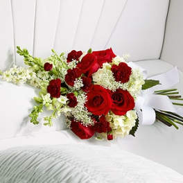 Bouquet of red roses and white flowers wrapped in white paper