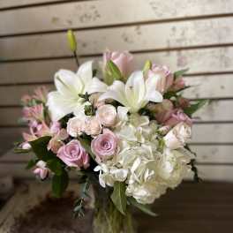 Pink and white bouquet with lilies, roses, and hydrangea in a glass vase