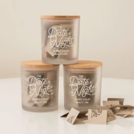 Three frosted jars with wooden lids labeled Date Night Jar