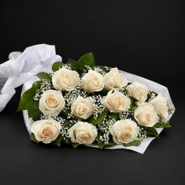 Bouquet of cream roses with baby's breath and white wrapping