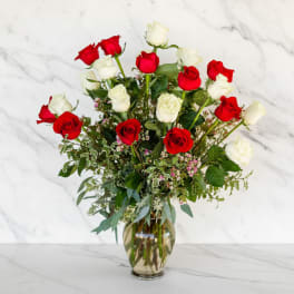 Red and white roses in a glass vase