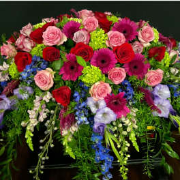 Large mixed bouquet with pink and red roses, magenta daisies, and purple flowers
