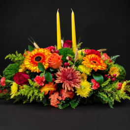 Autumn floral centerpiece with two yellow candles