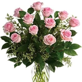 Pink roses arranged in a clear glass vase