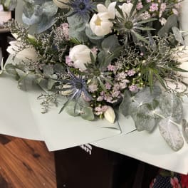 Bouquet of white tulips and pale pink flowers with eucalyptus