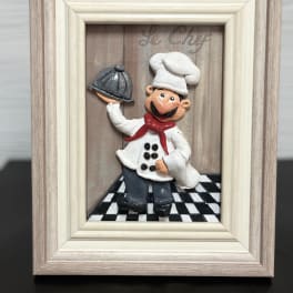 Framed chef figurine holding a serving tray