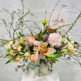 Pastel bouquet with roses, carnations, and alstroemeria in a white vase