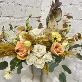 Peach and white rose arrangement in a white hatbox with dried accents