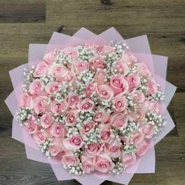 Pink rose bouquet with baby's breath wrapped in pink paper