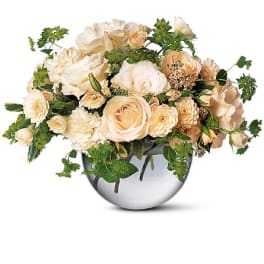 Cream roses and carnations arranged in a silver vase
