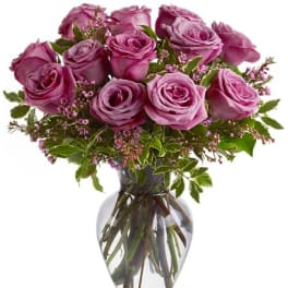 Pink roses arranged in a clear glass vase