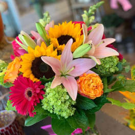 Bouquet with sunflowers, pink lilies, and orange roses