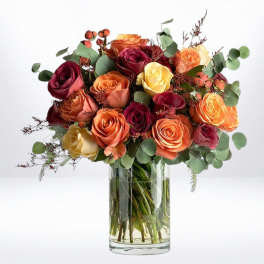 Bouquet of multicolored roses in a clear glass vase