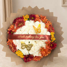 Round bouquet of white roses with orange and burgundy chrysanthemums