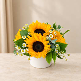 Sunflower bouquet in a white vase with small white daisies