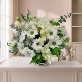 White bouquet with daisies and lilies in a low vase