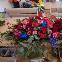 Large mixed bouquet with pink and red flowers and blue accents