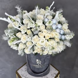 White rose bouquet with silver accents in a gray hatbox