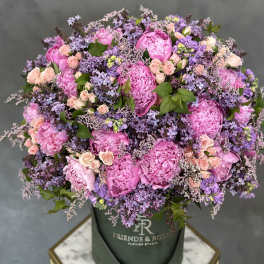 Large pink and lavender bouquet in a dark green hat box