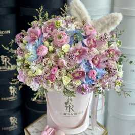 Pastel bouquet in a pink hatbox with plush bunny ears