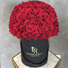 Large bouquet of red roses in a black hat box