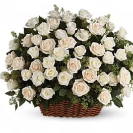 Basket of white roses with pale blush accents